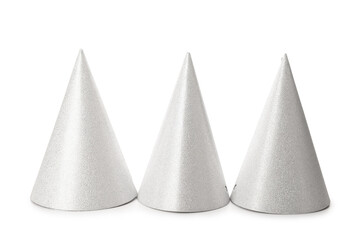 Three silver party hats on white background