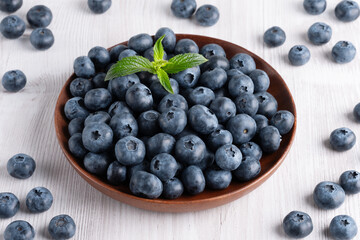Fresh blueberries on a wooden white table