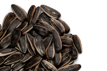 Roasted sunflower seeds on white background.