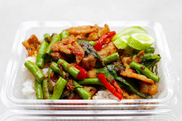 Rice topped with stir fried pork and red curry paste with yard-long bean