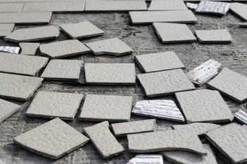Cracked brown tiles on cement floor