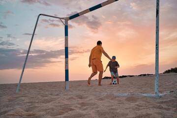 Father and Son playing football, family fun outdoors.