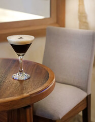 Elegant Espresso Martini on Wooden Table at a restaurant