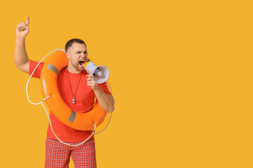 Young lifeguard with lifebuoy shouting into megaphone on yellow background