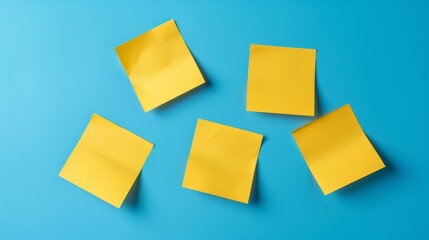 Five yellow sticky notes arranged on a bright blue background creating a vibrant contrast.