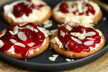 Open sweet sandwiches with cherries