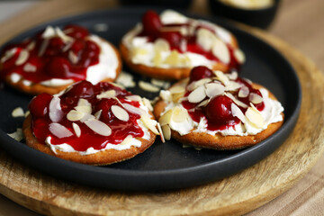 Open sweet sandwiches with cherries