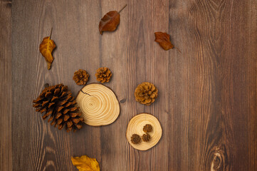 Cones and leaves on wooden background. Autumn composition. Top view, flat lay