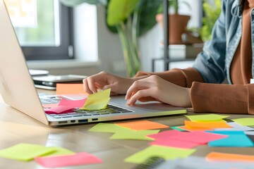 A dynamic mockup of blank stickers on a laptop, with a person working in a creative space, suitable for artistic and tech product branding