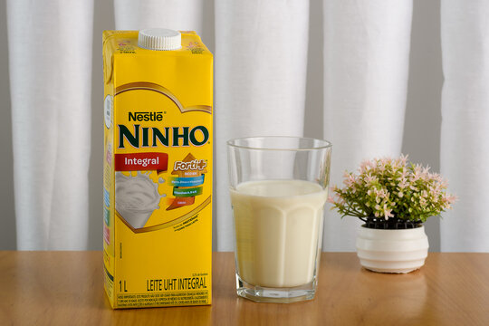 S&atilde;o Paulo, Brazil - July 15, 2024 
Leite Ninho Whole UHT milk, 1 liter, isolated on a wooden table	