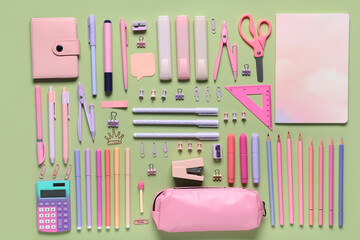 Set of school supplies on green background. Top view