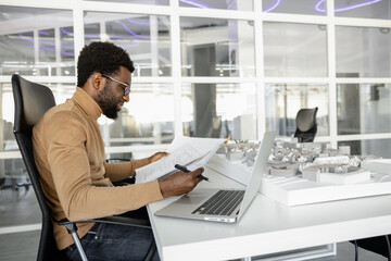 Confident man architect planning new developments in the office