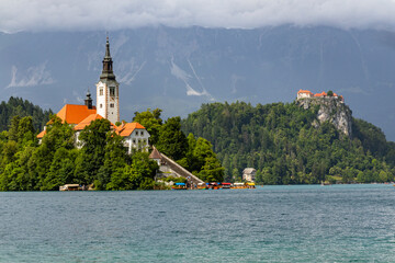 Panoramic view from Lake Bled, beauty heritage in Slovenia. Island with church and castle in the...