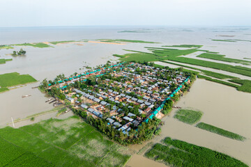 Aerial view showcasing the devastating impact of floods on villages in Northern Bangladesh, highlighting the submerged homes, affected communities, highlighting the severe impact and the resilience