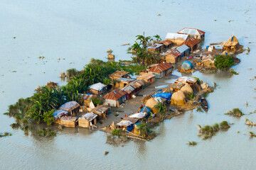 Aerial view showcasing the devastating impact of floods on villages in Northern Bangladesh, highlighting the submerged homes, affected communities, highlighting the severe impact and the resilience
