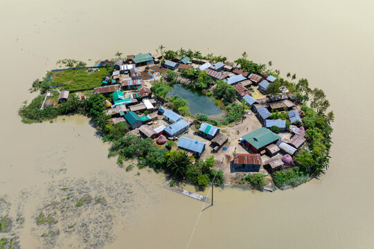 Aerial view showcasing the devastating impact of floods on villages in Northern Bangladesh, highlighting the submerged homes, affected communities, highlighting the severe impact and the resilience