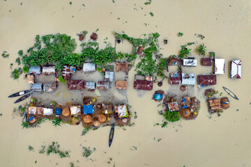 Aerial view showcasing the devastating impact of floods on villages in Northern Bangladesh, highlighting the submerged homes, affected communities, highlighting the severe impact and the resilience