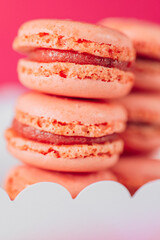 Sweet pink pastries. Macaron cakes set.white cardboard box filled with pink macarons set against a pink backdrop.French pastries set. macarons close-up background.Assorted sweet pastries. 