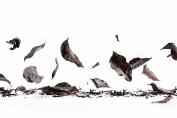 Fototapeta premium A bunch of autumn leaves flying through the air, swirling and twirling with each gust