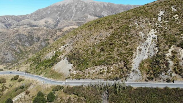 Aerial drone view of a trail winding through dramatic mountains and turquoise alpine lakes on the way to Trig M in the Torlesse Tussocklands near Springfield, Canterbury, South Island, New Zealand