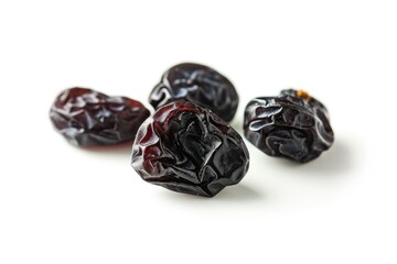 A cluster of dried raisins on a clean and flat white surface