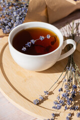 Lavender flowers with herbal cup of tea. Concept of Herbal medicine natural remedy. Organic relieving stress. Healthy beverage fresh delicious floral hot tea. Antispasmodic effect naturopathy concept