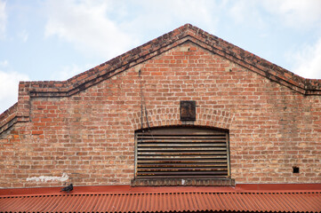 Background of an Old Red Brick Building with an Arched Roof.