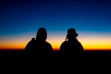 Adventure Friendship at Sunset: Silhouetted Group of Friends Embrace Nature's Beauty, Summer Journey of Hiking and Trekking Together in Majestic Mountain Landscapes, Enjoying Activities Sunrise Views