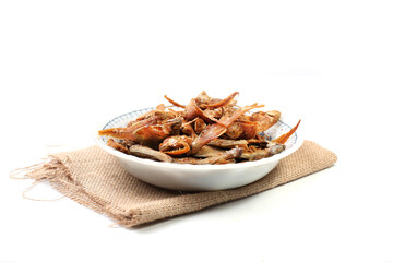 Ikan asin goreng or fried salted fish is one of traditional Indonesian food, isolated on white background, dried salted fish, good for article