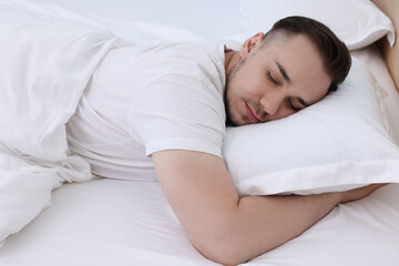 Bedtime. Handsome man sleeping in bed indoors