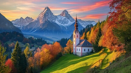 Naklejka premium Beautiful evening view of Germany's countryside featuring Maria Gern church and Hochkalter peak during autumn.