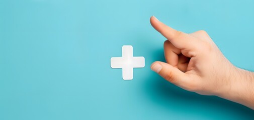 Hand Pointing at White Cross Symbol Medical Concept