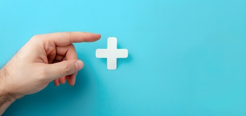 Obraz premium Hand Pointing at White Cross Symbol on Blue Background