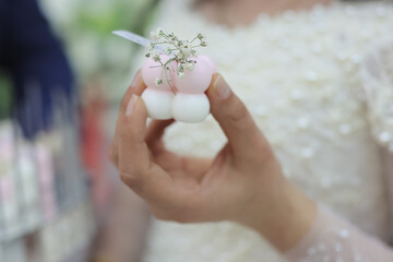 Cloud-shaped candles on gold bases with dried flowers, arranged elegantly on a tray