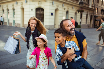 Joyful diverse family having fun on a city walk