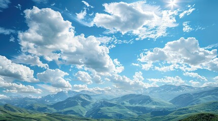 Mountain range under a clear blue sky with soft, white clouds drifting