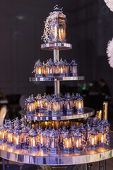 Candle holders adorned with sparkling crystals, elegantly displayed on a circular mirror