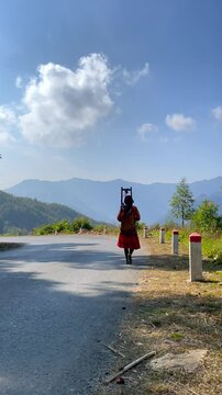 Vietnamese farmer in traditional clothes walking in mountain village, Vietnam