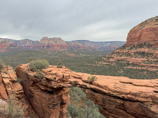 Discover the iconic Devil's Bridge in Sedona, Arizona, framed by stunning red rocks and sandstone cliffs. This scenic view showcases the natural arch and rugged terrain, ideal for outdoor adventure.