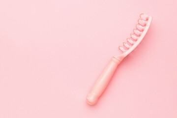 Minimalistic Pink Hairbrush on Soft Pastel Background for Trendy Beauty and Self-Care Themes