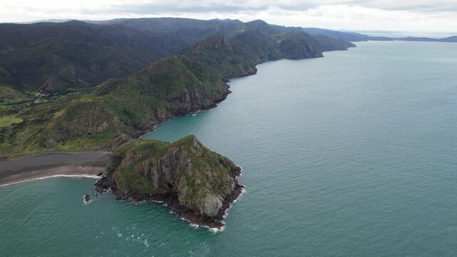 Waitakere Ranges And Paratutae Island At The Mouth Of Manukau Harbour In Auckland, New Zealand. aerial pullback shot