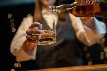 Barwoman pouring whiskey whiskey glass beautiful night