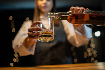 Barwoman pouring whiskey whiskey glass beautiful night