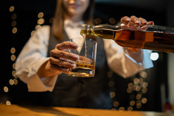 Barwoman pouring whiskey whiskey glass beautiful night