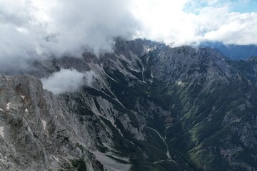  A stunning aerial view of Logarska Dolina in Slovenia, showcasing its breathtaking alpine valley, lush greenery, and the serene beauty of the Kamnik-Savinja Alps