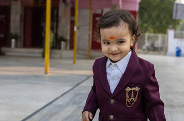 cute indian toddler walking in suit with different facial expression at outdoor from flat angle