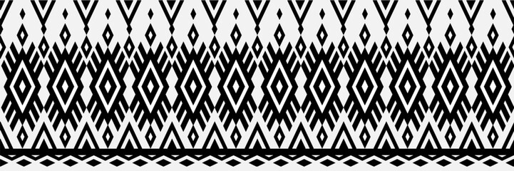 A black and white patterned fabric with diamond shapes. The pattern is very intricate and detailed. The fabric is likely to be used for clothing or home decor