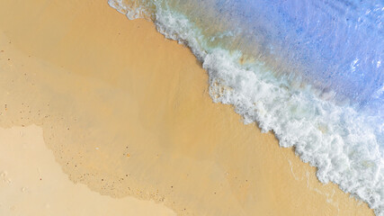 Top view beach sand background for summer vacation concept. Beach nature and summer seawater with sunlight light sandy beach Sparkling sea water	