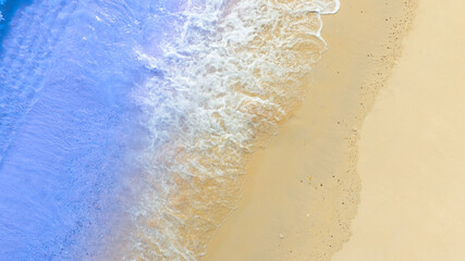 Top view beach sand background for summer vacation concept. Beach nature and summer seawater with sunlight light sandy beach Sparkling sea water	