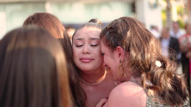 Emotional friends women crying at wedding. Bride cry with her girl friends after getting married